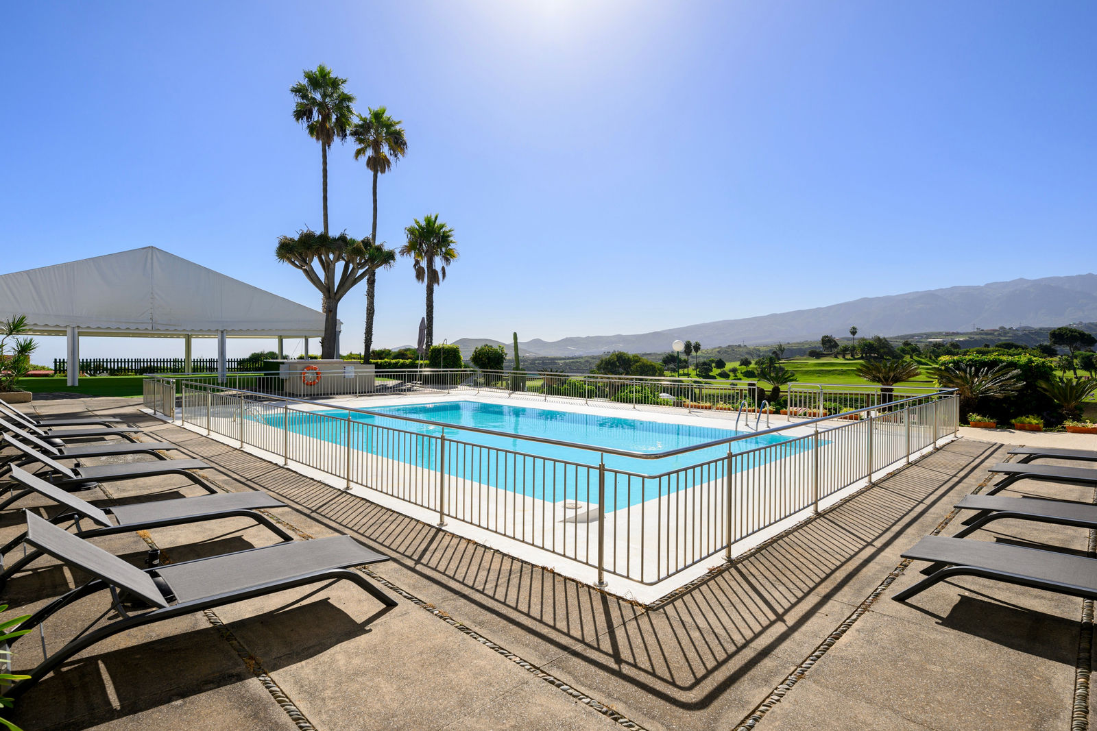 View over the pool, golf course and mountains
